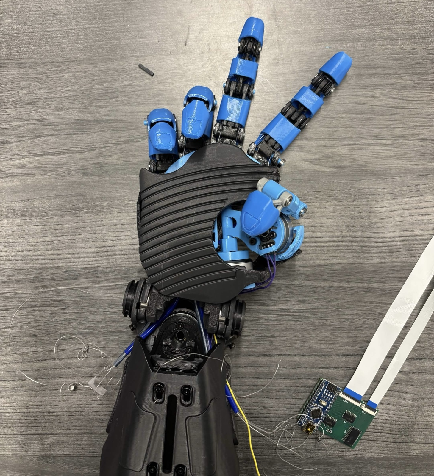 3D-printed humanoid hand with tendon-driven fingers and a control board